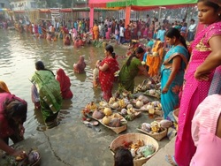Devotees worshiping the god by submerging themselves in the pond. Those who keep fast are to stay in that way until the prayer is over. It is done for the setting and the rising sun. Those who do not have fast cannot go into the river while the puja is being performed.