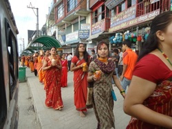 Devote Hindu women walking barefoot towards the Shiva temple to offer the sacred water to the Lord.